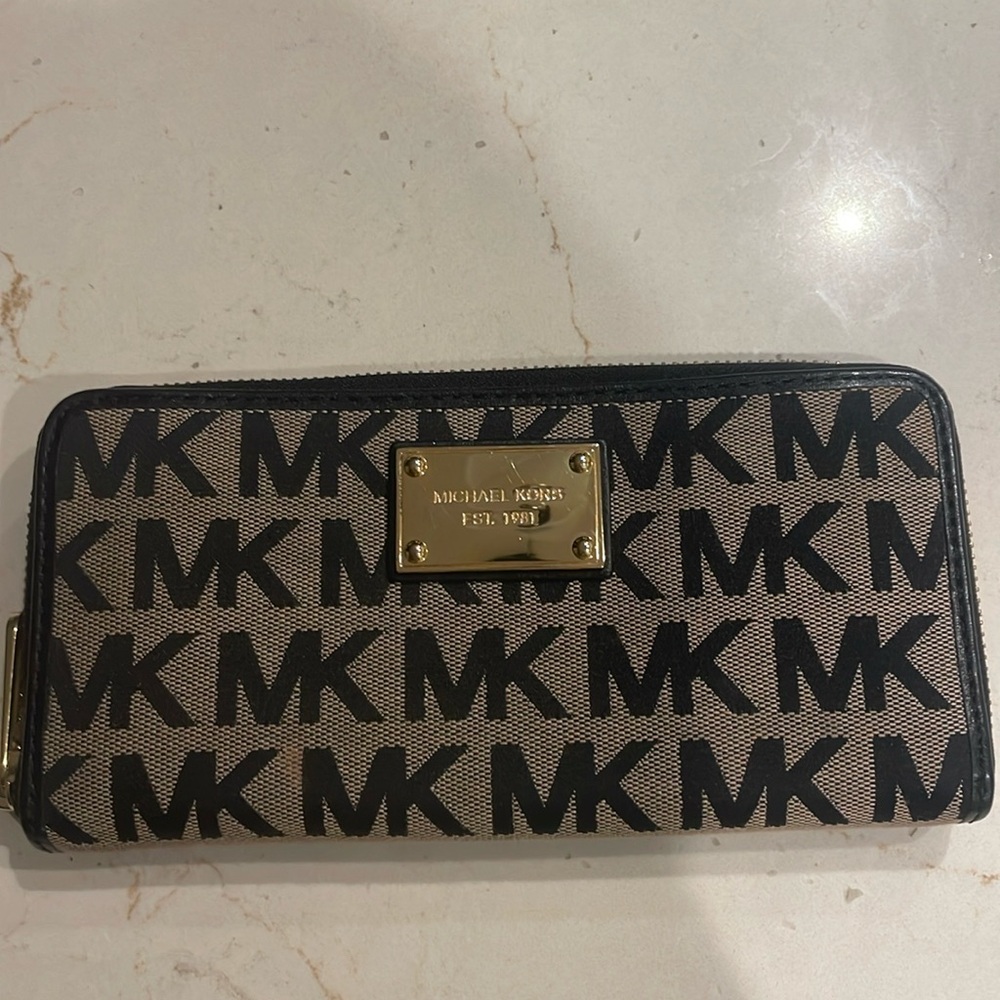 The brand is Michael Kors in their large wallet style